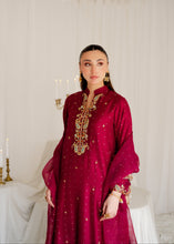 Load image into Gallery viewer, Woman wearing a red embroidered dress with gold details against a white curtain background