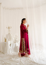 Load image into Gallery viewer, Woman in a red and gold traditional outfit standing in a white room with draped fabric.