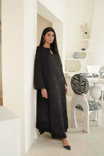 تصویر گیلری ویور میں لوڈ کریں، A woman wearing a long black embroidered dress in modern white interior hallway.
