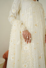 Load image into Gallery viewer, An off-white/cream embroidered traditional dress with floral lace detailing and a matching dupatta, shown on a model with rings.
